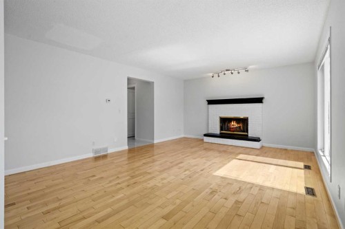 88 Sandringham Close Nw, Calgary, AB - Indoor Photo Showing Living Room With Fireplace