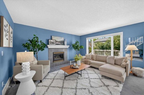 232 Douglas Glen Close Se, Calgary, AB - Indoor Photo Showing Living Room With Fireplace