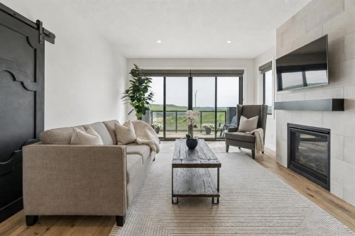 220 Precedence View, Cochrane, AB - Indoor Photo Showing Living Room With Fireplace