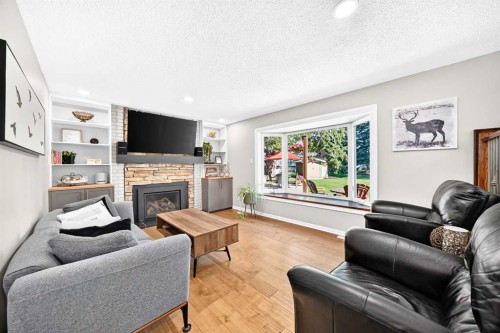 10416 Mapleridge Crescent Se, Calgary, AB - Indoor Photo Showing Living Room With Fireplace