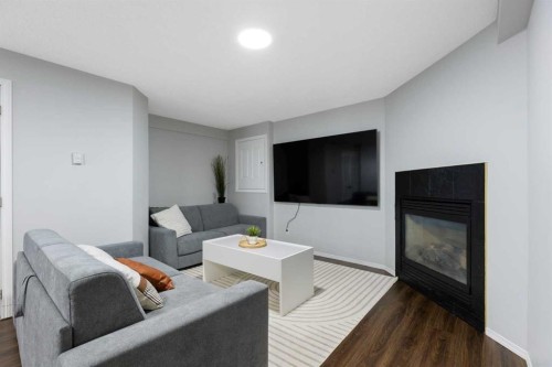 13 Somerset Park Sw, Calgary, AB - Indoor Photo Showing Living Room With Fireplace