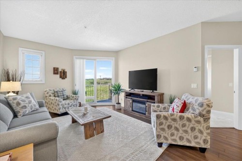 2305-15 Sunset Square, Cochrane, AB - Indoor Photo Showing Living Room