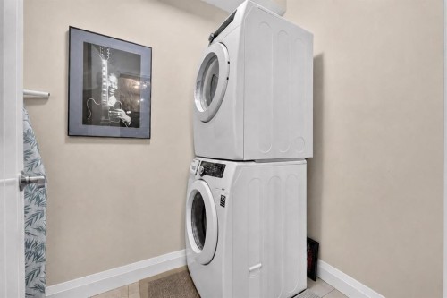 2305-15 Sunset Square, Cochrane, AB - Indoor Photo Showing Laundry Room