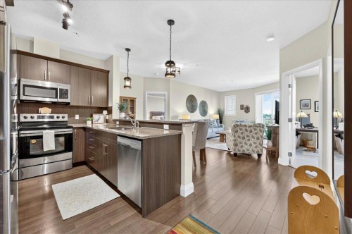 2305-15 Sunset Square, Cochrane, AB - Indoor Photo Showing Kitchen With Stainless Steel Kitchen With Upgraded Kitchen