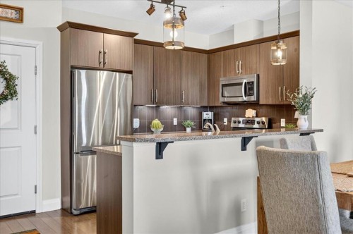 2305-15 Sunset Square, Cochrane, AB - Indoor Photo Showing Kitchen With Stainless Steel Kitchen