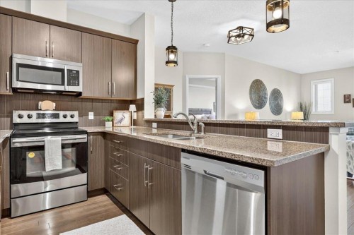 2305-15 Sunset Square, Cochrane, AB - Indoor Photo Showing Kitchen With Stainless Steel Kitchen With Double Sink