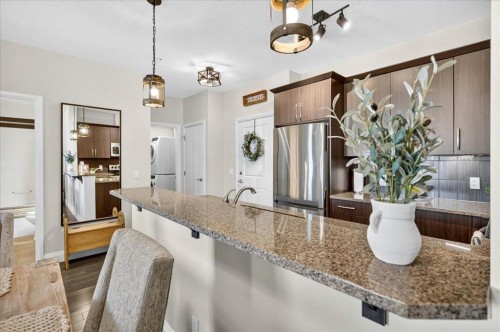 2305-15 Sunset Square, Cochrane, AB - Indoor Photo Showing Kitchen With Stainless Steel Kitchen With Upgraded Kitchen