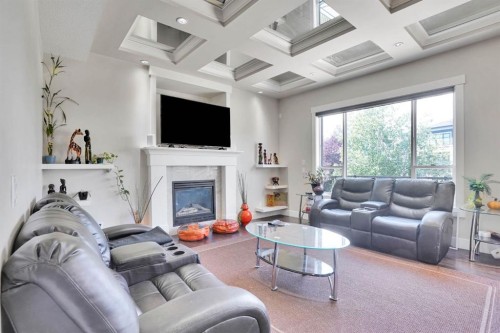 113 Kinniburgh Bay, Chestermere, AB - Indoor Photo Showing Living Room With Fireplace