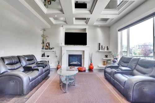 113 Kinniburgh Bay, Chestermere, AB - Indoor Photo Showing Living Room With Fireplace