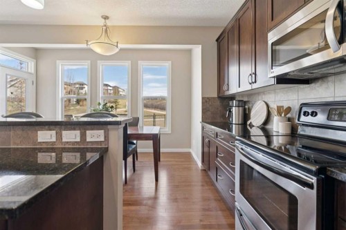 161 Heritage Bay, Cochrane, AB - Indoor Photo Showing Kitchen With Upgraded Kitchen