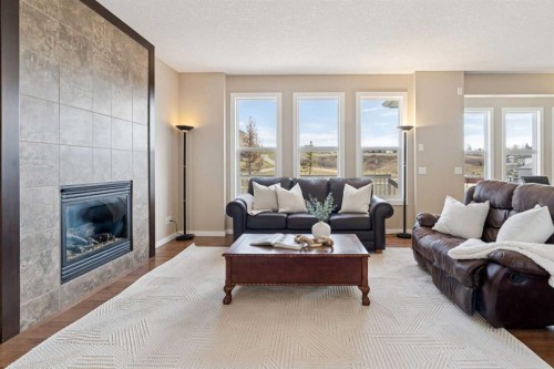 161 Heritage Bay, Cochrane, AB - Indoor Photo Showing Living Room With Fireplace