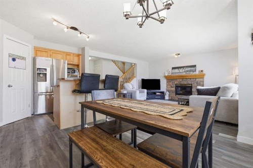 134 Prestwick Landing Se, Calgary, AB - Indoor Photo Showing Dining Room With Fireplace