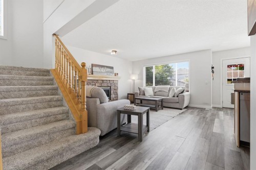 134 Prestwick Landing Se, Calgary, AB - Indoor Photo Showing Living Room With Fireplace