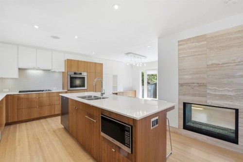 4935 10 Avenue Sw, Calgary, AB - Indoor Photo Showing Kitchen With Fireplace With Double Sink