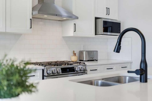136 Sunrise Common, Cochrane, AB - Indoor Photo Showing Kitchen With Double Sink With Upgraded Kitchen