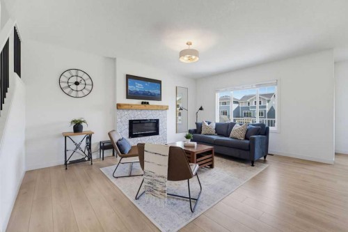 136 Sunrise Common, Cochrane, AB - Indoor Photo Showing Living Room With Fireplace