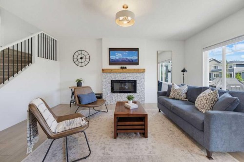 136 Sunrise Common, Cochrane, AB - Indoor Photo Showing Living Room With Fireplace