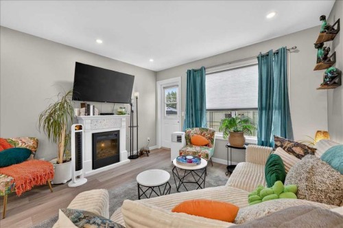 23-33 Stonegate Drive Nw, Airdrie, AB - Indoor Photo Showing Living Room With Fireplace