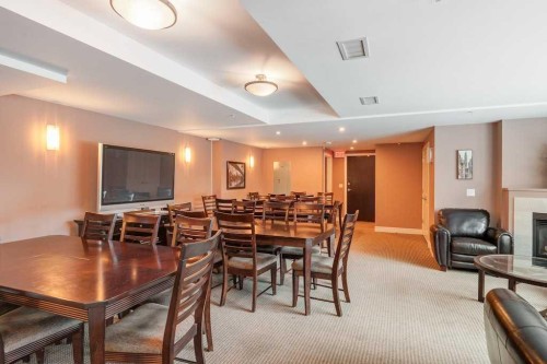 604-920 5 Avenue Sw, Calgary, AB - Indoor Photo Showing Dining Room With Fireplace