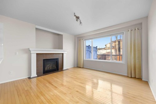 73 Sunset Heights, Cochrane, AB - Indoor Photo Showing Living Room With Fireplace
