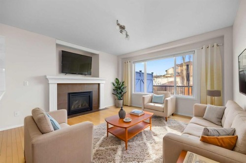 73 Sunset Heights, Cochrane, AB - Indoor Photo Showing Living Room With Fireplace