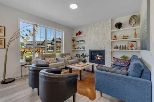 168 Magnolia Manor Se, Calgary, AB - Indoor Photo Showing Living Room With Fireplace