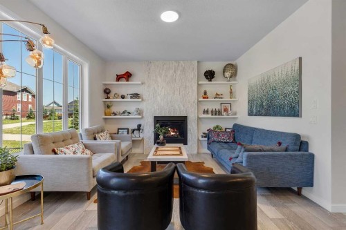 168 Magnolia Manor Se, Calgary, AB - Indoor Photo Showing Living Room With Fireplace
