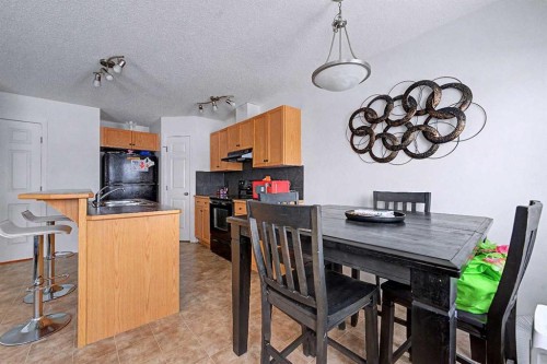 102-800 Yankee Valley Boulevard Se, Airdrie, AB - Indoor Photo Showing Dining Room