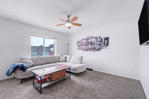 102-800 Yankee Valley Boulevard Se, Airdrie, AB - Indoor Photo Showing Living Room