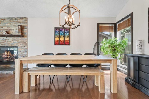 15 Lock Crescent, Okotoks, AB - Indoor Photo Showing Dining Room With Fireplace