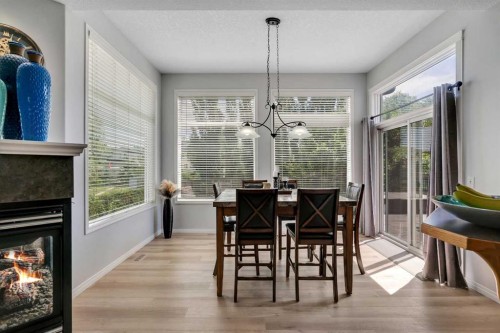 54 Thomas Street Nw, Langdon, AB - Indoor Photo Showing Dining Room With Fireplace