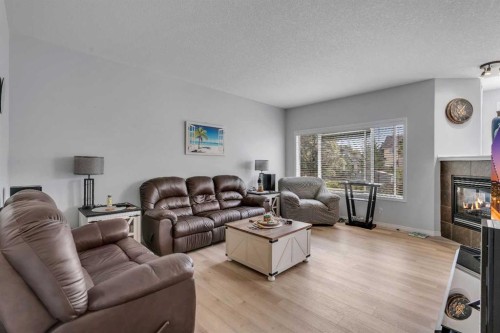 54 Thomas Street Nw, Langdon, AB - Indoor Photo Showing Living Room With Fireplace