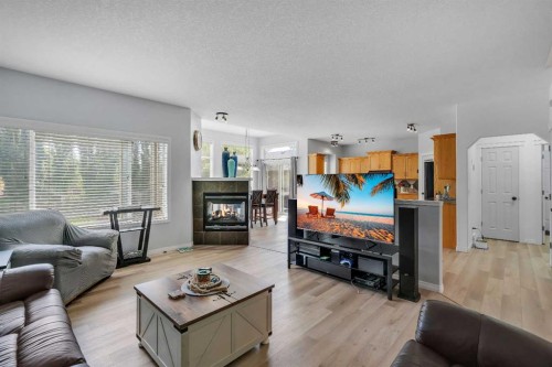 54 Thomas Street Nw, Langdon, AB - Indoor Photo Showing Living Room With Fireplace