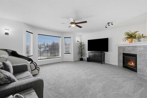 218 Bridlewood Place Sw, Calgary, AB - Indoor Photo Showing Living Room With Fireplace