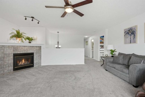218 Bridlewood Place Sw, Calgary, AB - Indoor Photo Showing Living Room With Fireplace