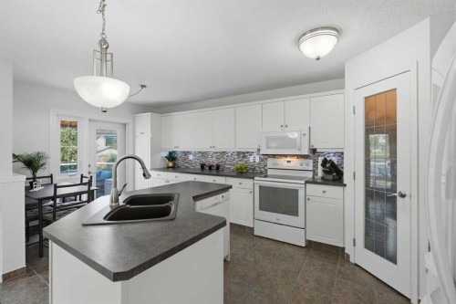 218 Bridlewood Place Sw, Calgary, AB - Indoor Photo Showing Kitchen With Double Sink