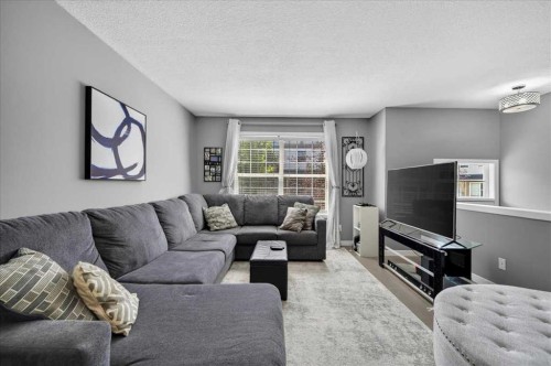 113 Tuscany Springs Gardens Nw, Calgary, AB - Indoor Photo Showing Living Room With Fireplace
