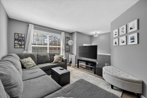 113 Tuscany Springs Gardens Nw, Calgary, AB - Indoor Photo Showing Living Room With Fireplace