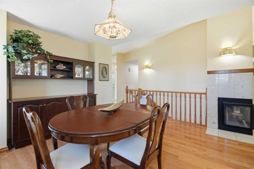 135 Shawnee Rise Sw, Calgary, AB - Indoor Photo Showing Dining Room With Fireplace