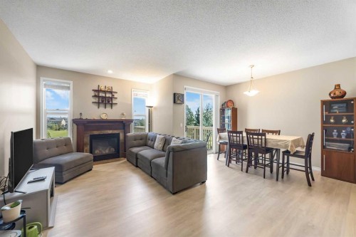 32 Panatella Common Nw, Calgary, AB - Indoor Photo Showing Living Room With Fireplace