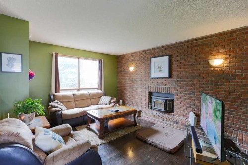89 Athabasca Crescent, Crossfield, AB - Indoor Photo Showing Living Room With Fireplace