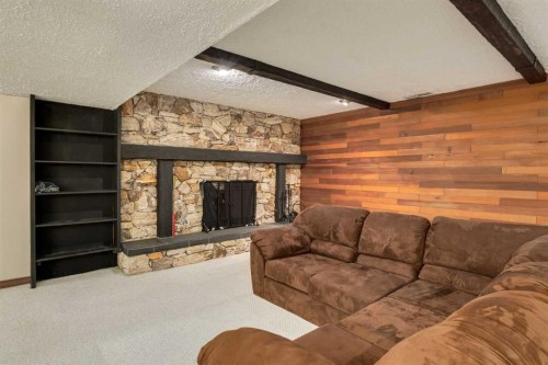 228 Maple Court Crescent Se, Calgary, AB - Indoor Photo Showing Living Room With Fireplace
