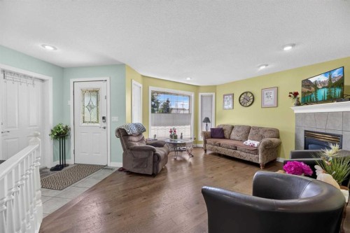 1514 Mary Place, Didsbury, AB - Indoor Photo Showing Living Room With Fireplace