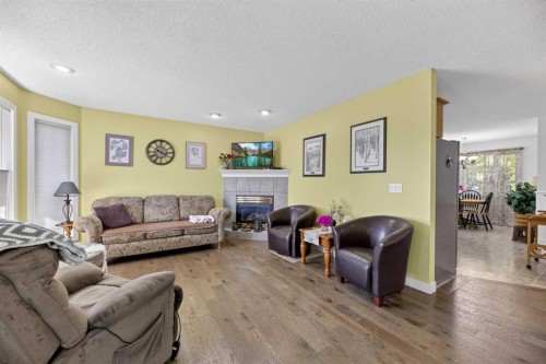 1514 Mary Place, Didsbury, AB - Indoor Photo Showing Living Room With Fireplace