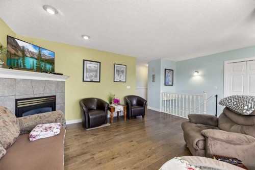 1514 Mary Place, Didsbury, AB - Indoor Photo Showing Living Room With Fireplace