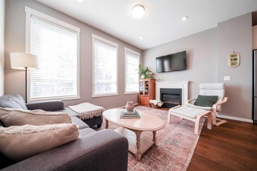 211 Copperpond Common Se, Calgary, AB - Indoor Photo Showing Living Room With Fireplace