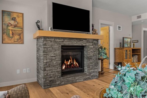 102-707 Spring Creek Drive, Canmore, AB - Indoor Photo Showing Living Room With Fireplace