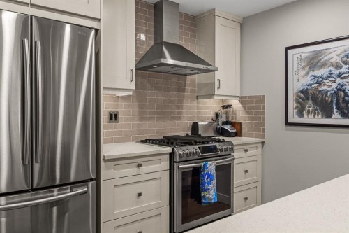 102-707 Spring Creek Drive, Canmore, AB - Indoor Photo Showing Kitchen With Stainless Steel Kitchen With Upgraded Kitchen