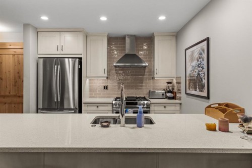 102-707 Spring Creek Drive, Canmore, AB - Indoor Photo Showing Kitchen With Double Sink With Upgraded Kitchen
