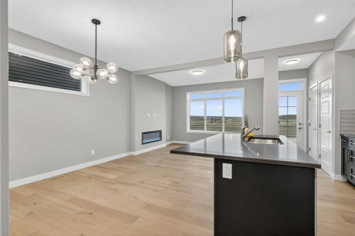 120 Southbow Avenue, Cochrane, AB - Indoor Photo Showing Kitchen With Fireplace